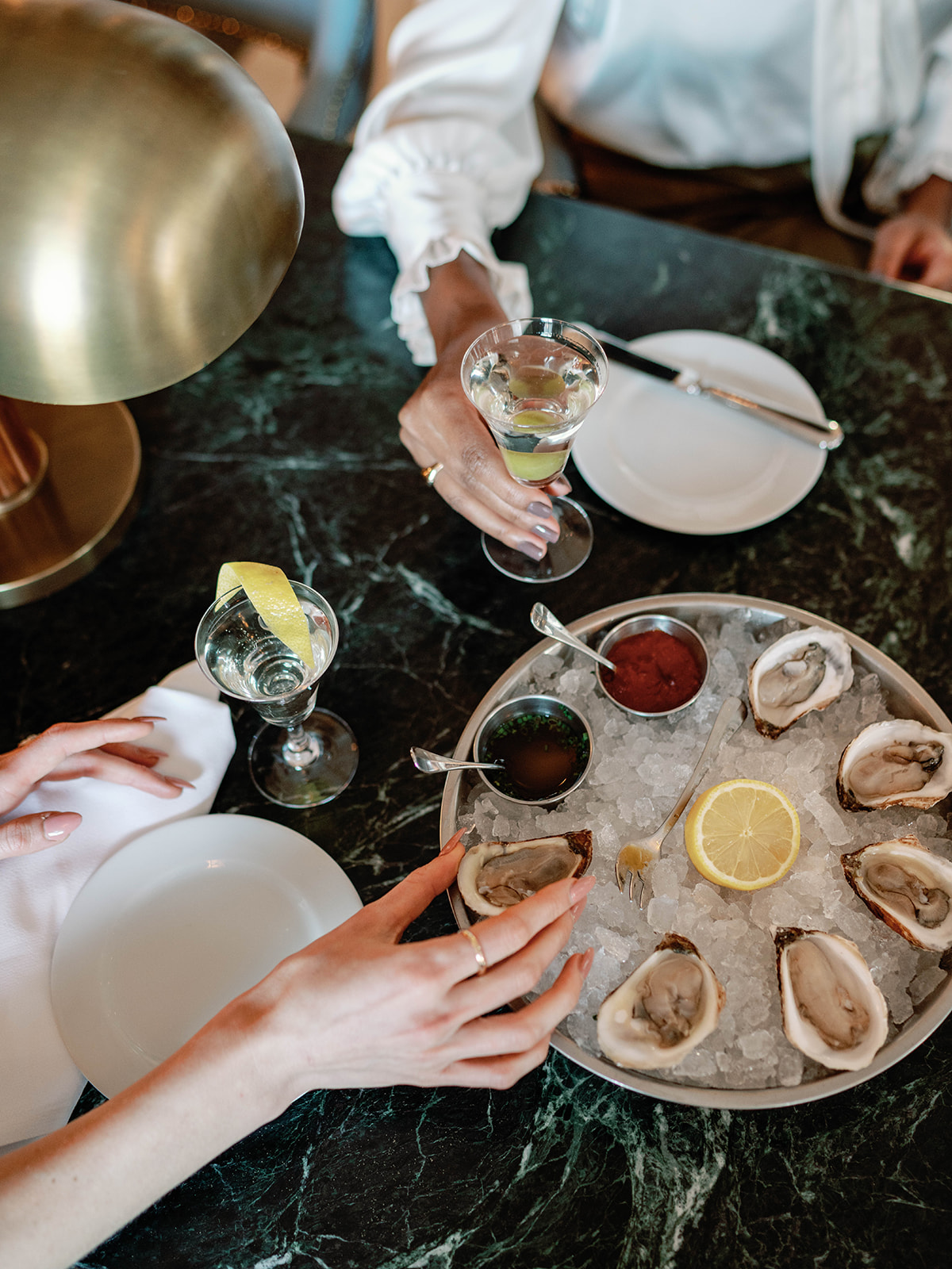 An elegantly decorated lounge area at Riggs DC, featuring friends enjoying their drink and appetiser together.