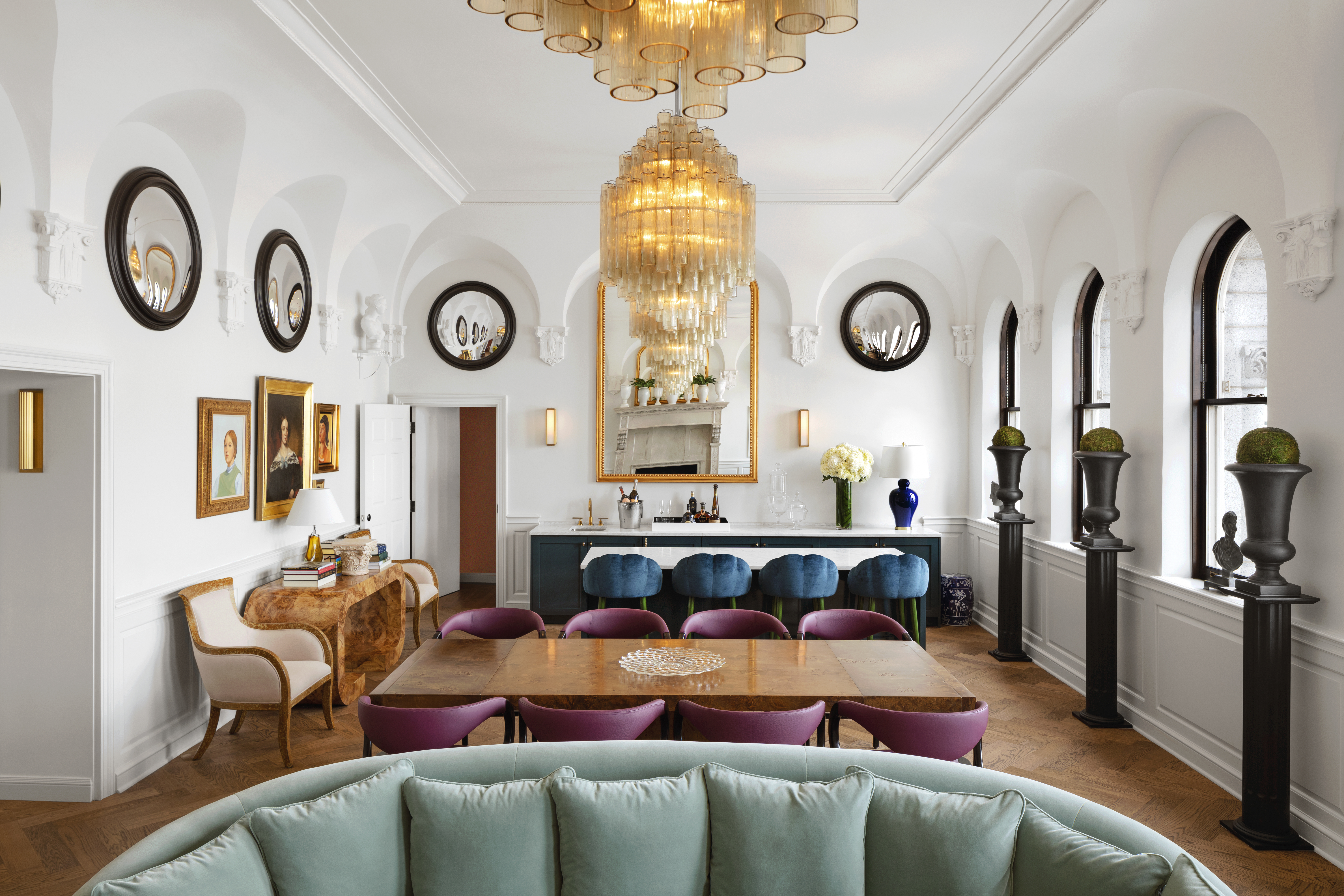 The wet bar in the Riggs Suite, featuring a well-stocked bar and modern design with multiple seating areas.