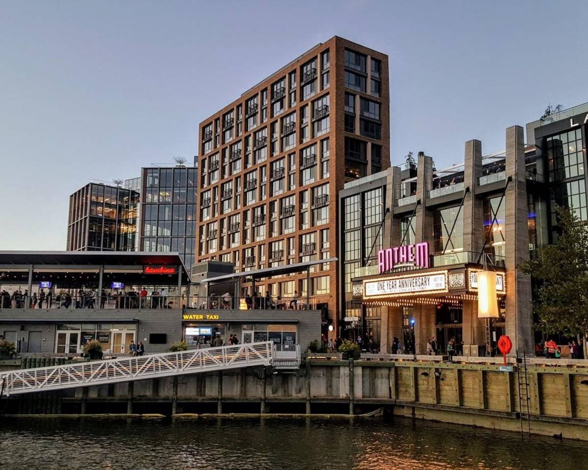 The Anthem highlights its modern design and concert venue in a clear sky evening.