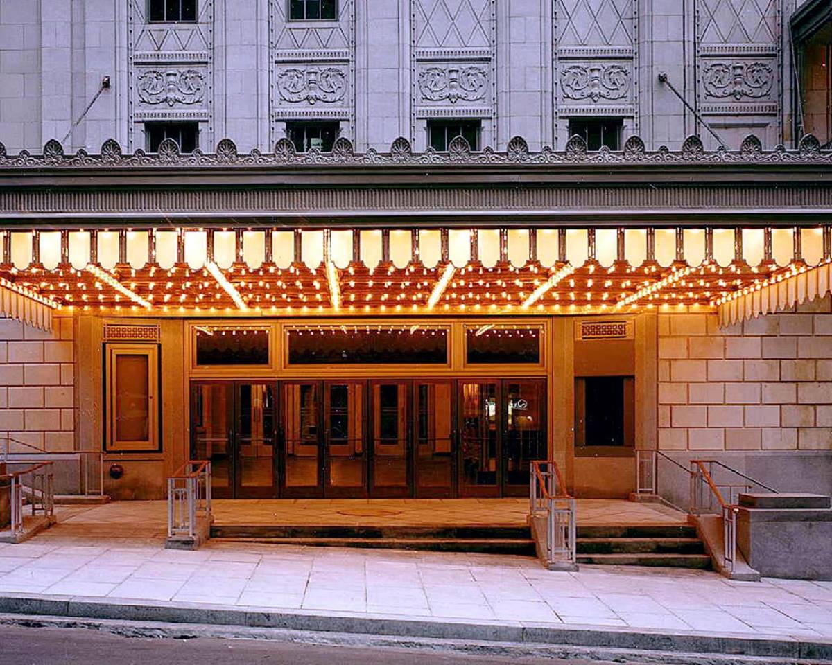 The Warner Theater, featuring its external grand entrance and historical significance.