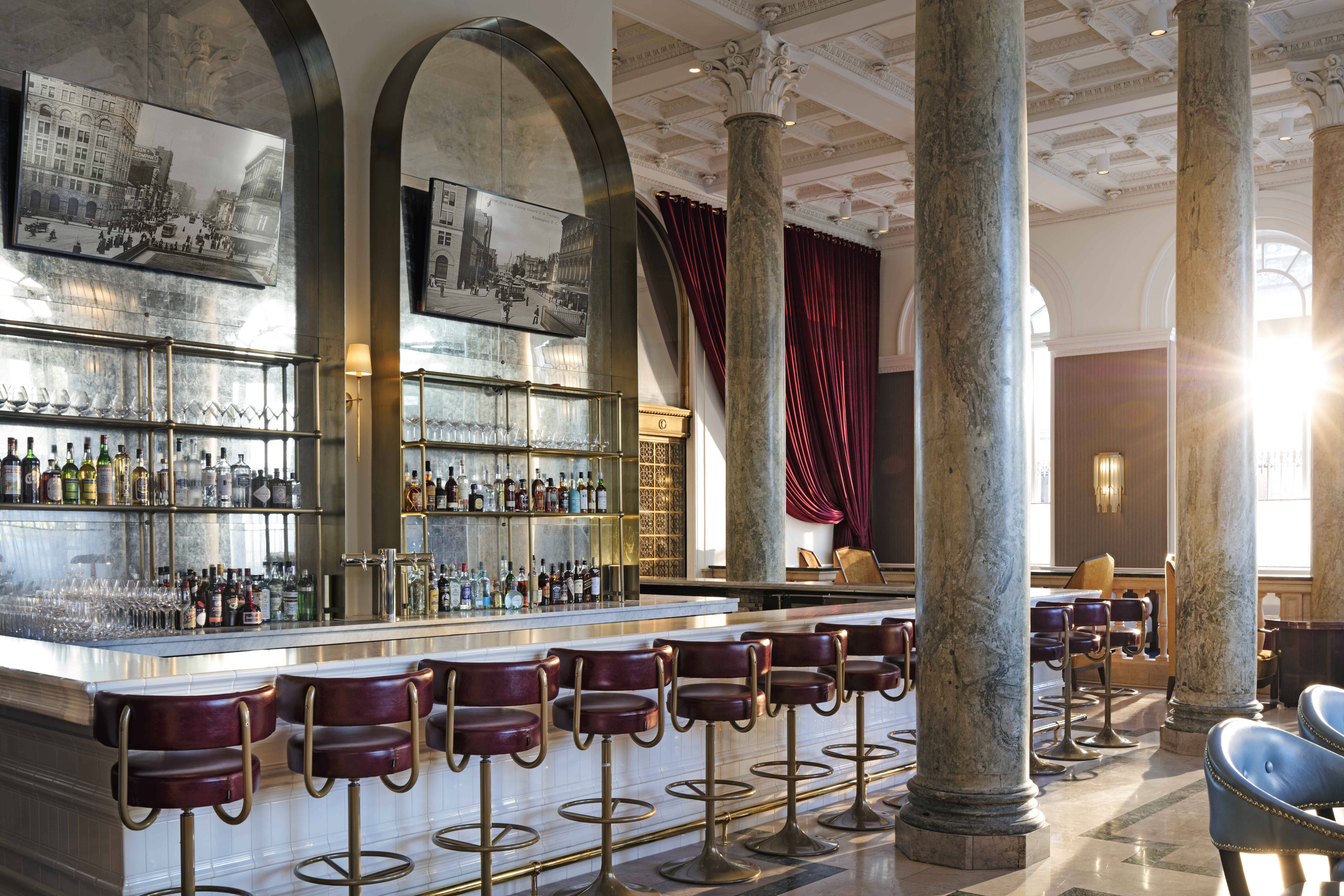 The bar area at Café Riggs, featuring a chic design with stylish seating and a large selection of drinks for everyone taste. 