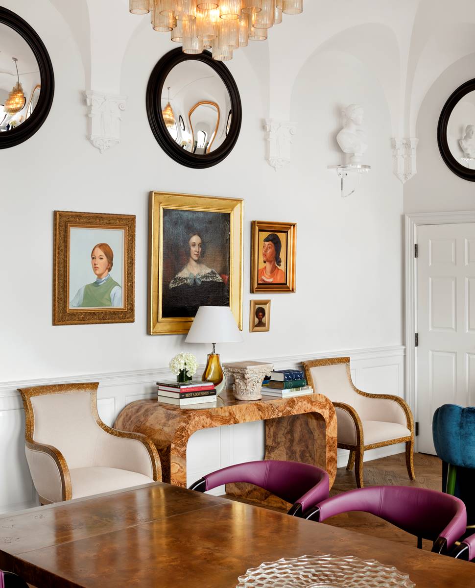 A detailed design shot from the Riggs Suite, showcasing intricate craftsmanship, luxurious style with paintings and chairs.
